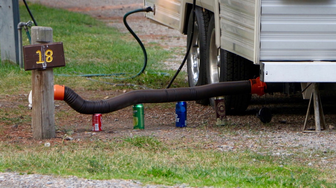 Rented RV at a dump station with sewer hose connected